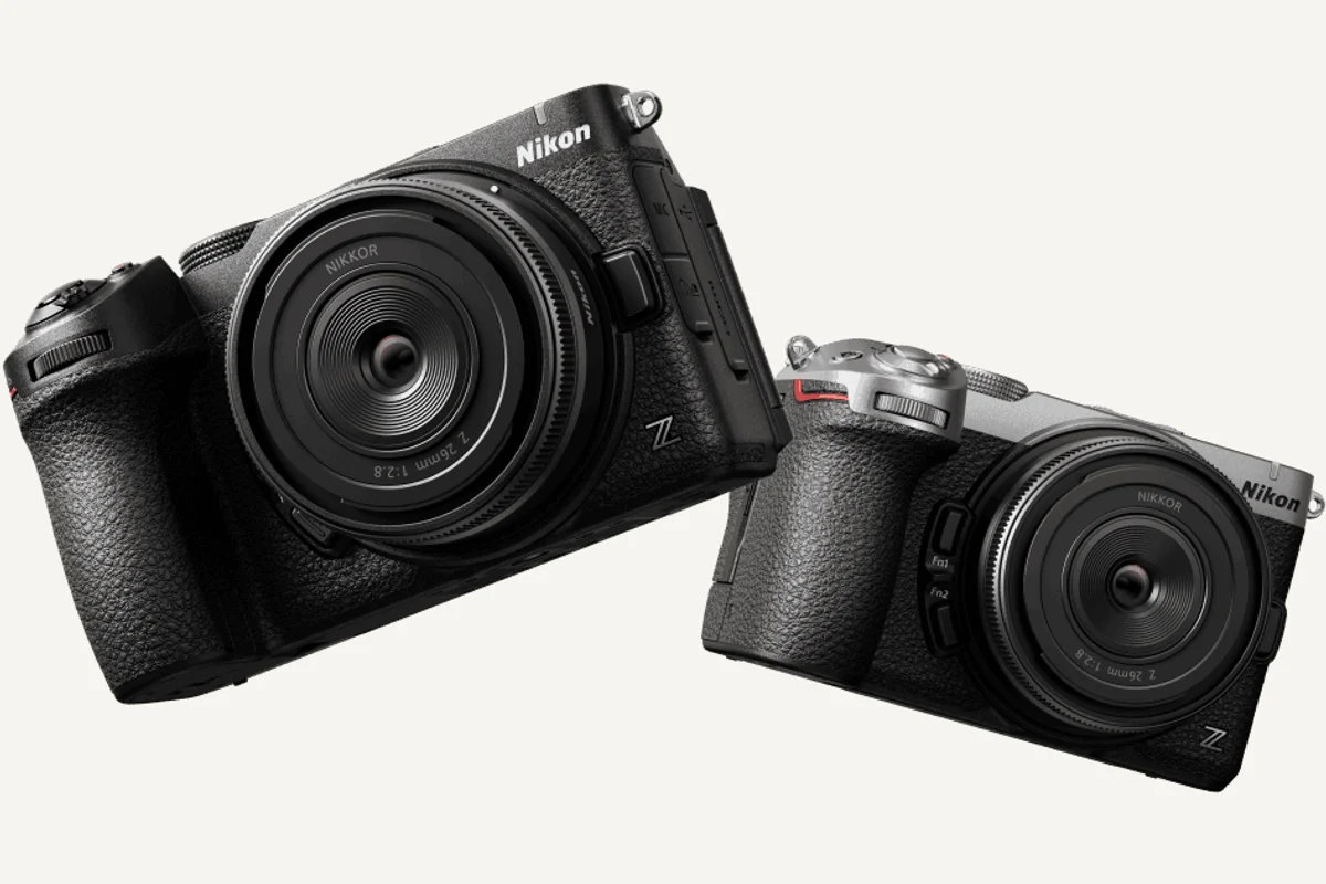 Official Nikon photograph showing black and silver Z5IIC cameras with optional 26mm lenses, which are not included with the body-only configuration