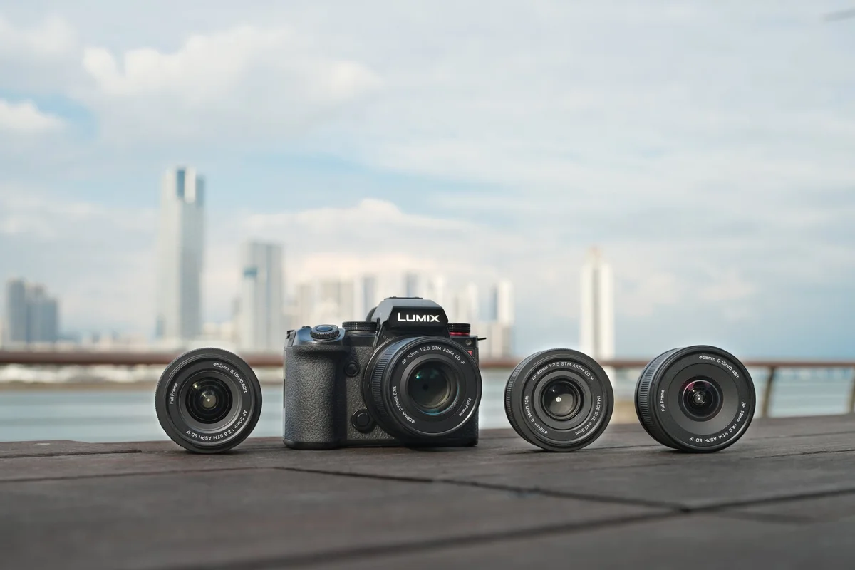 Viltrox press photograph of four Air L-Mount primes, with the 50mm mounted on a Panasonic LUMIX camera