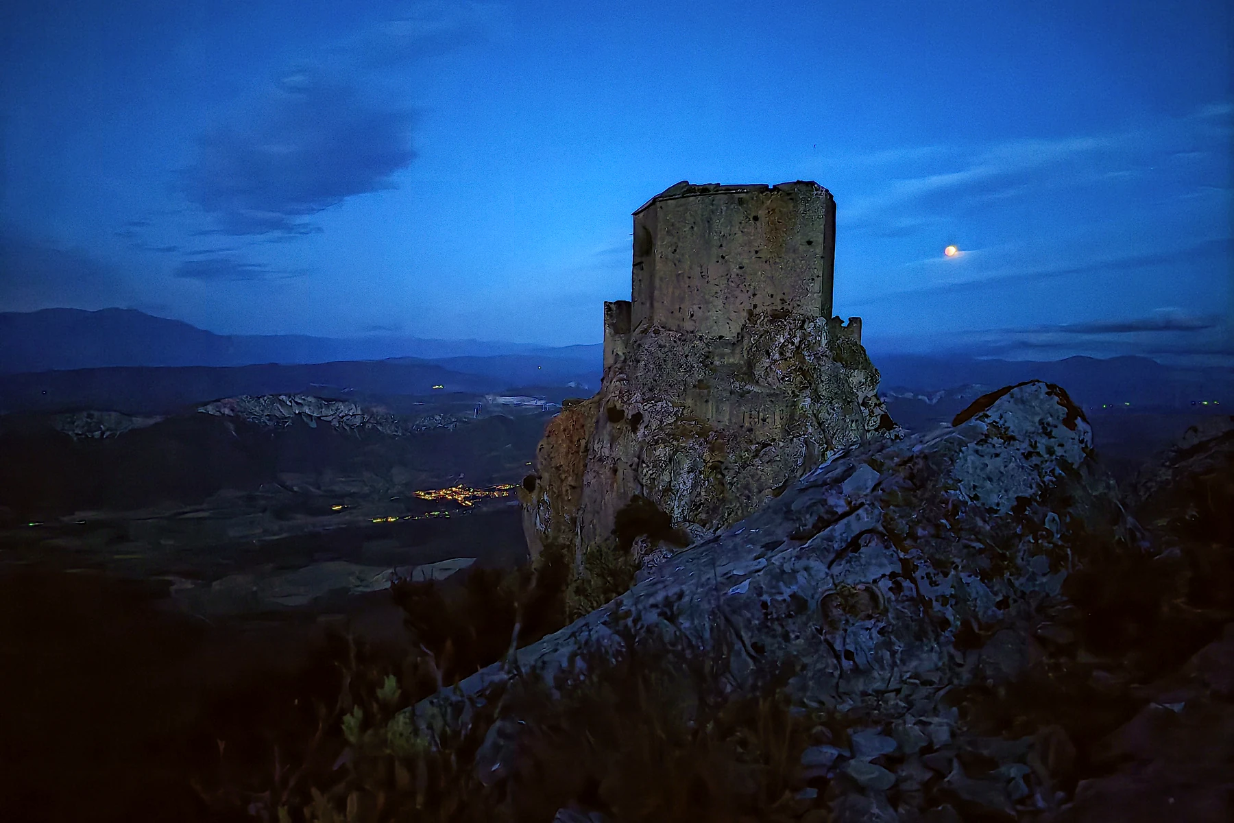 Partial lunar eclipse to the right of Quéribus Castle photographed with an Honor Magic V2 before dawn