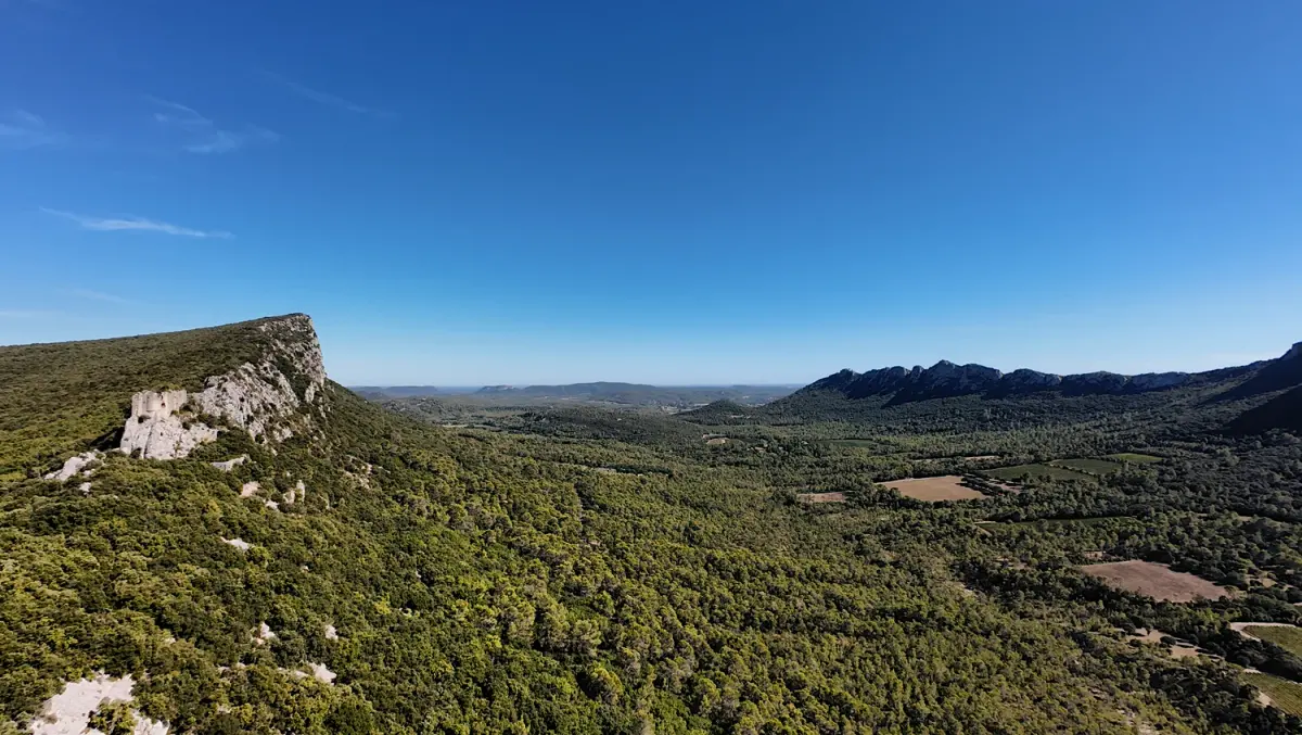 Viviourès on the left and the distant Montferrand ridge on the right, separated by a wooded valley in southern France